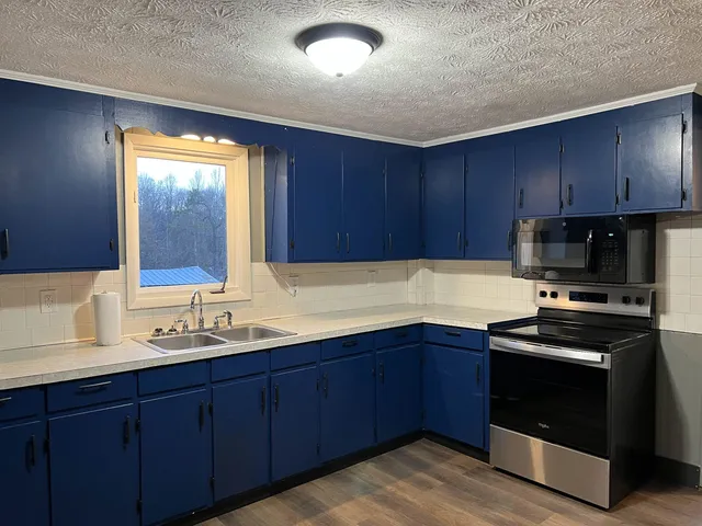 a kitchen with wooden cabinets and stainless steel appliances