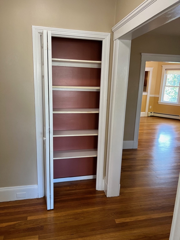 84 Melrose Street, Unit 1 Arlington, MA 02474 - Photo 12 of 42 a view of an empty room with wooden floor and a window