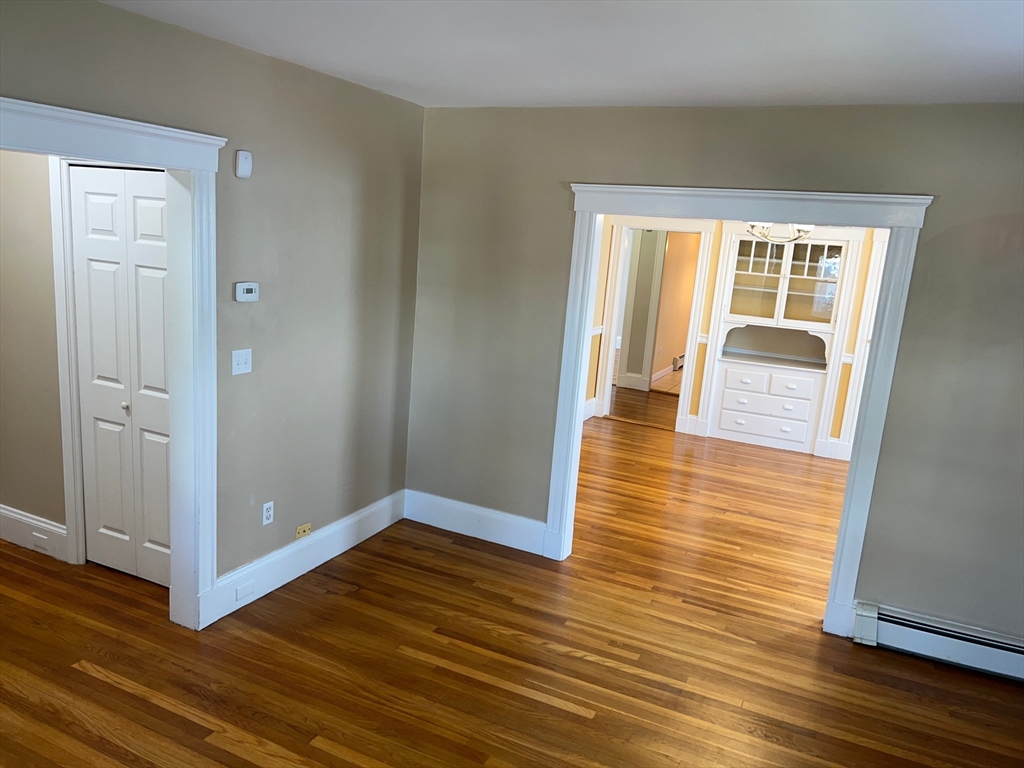 84 Melrose Street, Unit 1 Arlington, MA 02474 - Photo 16 of 42 wooden floor in an empty room with a window