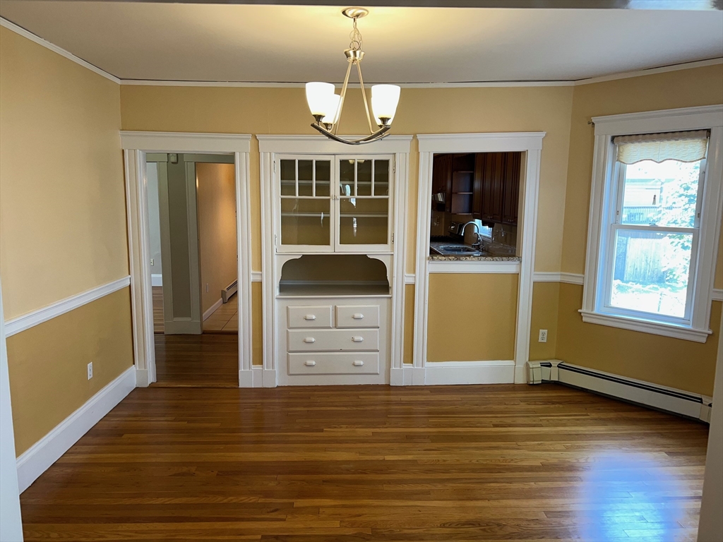 84 Melrose Street, Unit 1 Arlington, MA 02474 - Photo 18 of 42 a view of a living room with hardwood floor and a ceiling fan
