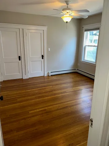 wooden floor in an empty room with a window