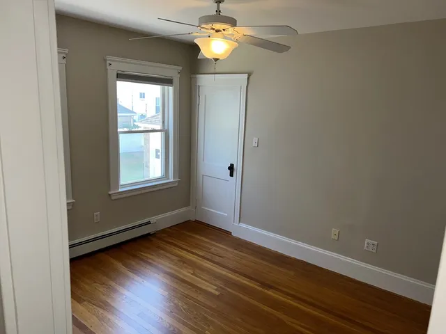 a view of room with window and wooden floor