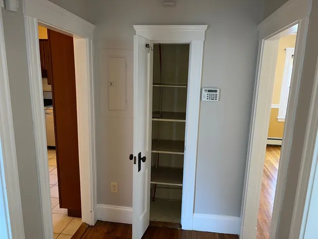 a view of walk in closet with empty racks