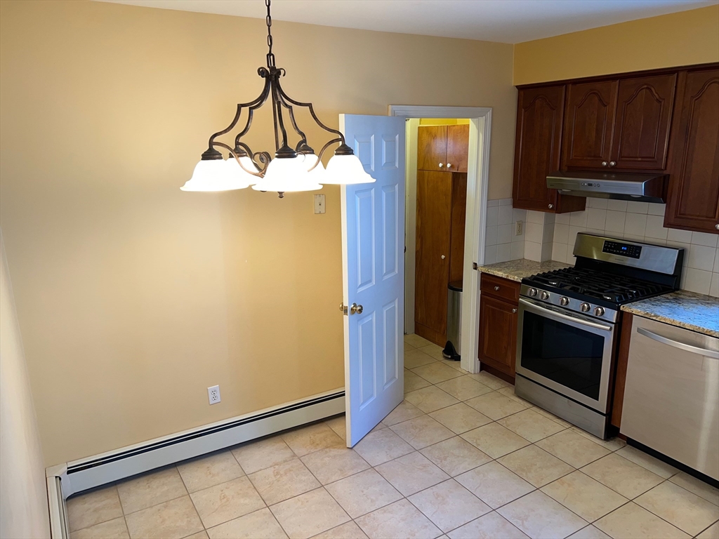 84 Melrose Street, Unit 1 Arlington, MA 02474 - Photo 28 of 42 a kitchen with stainless steel appliances a refrigerator and a stove top oven