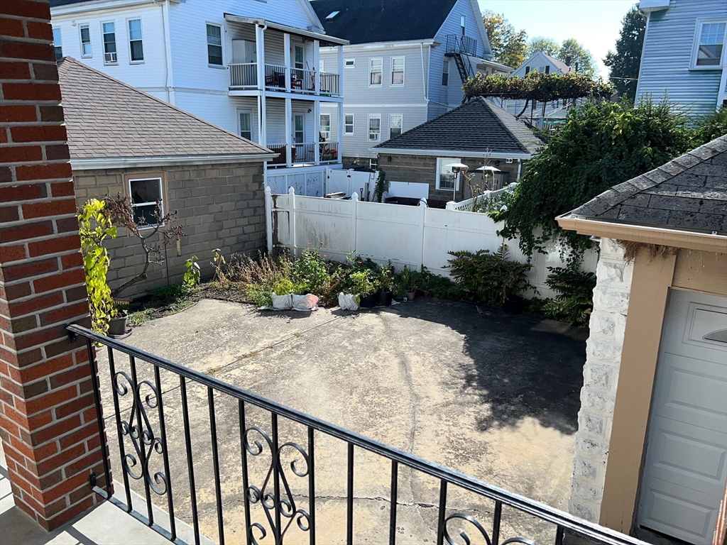 84 Melrose Street, Unit 1 Arlington, MA 02474 - Photo 32 of 42 a patio with table and chairs