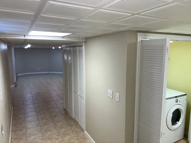 a view of a hallway with washer and dryer