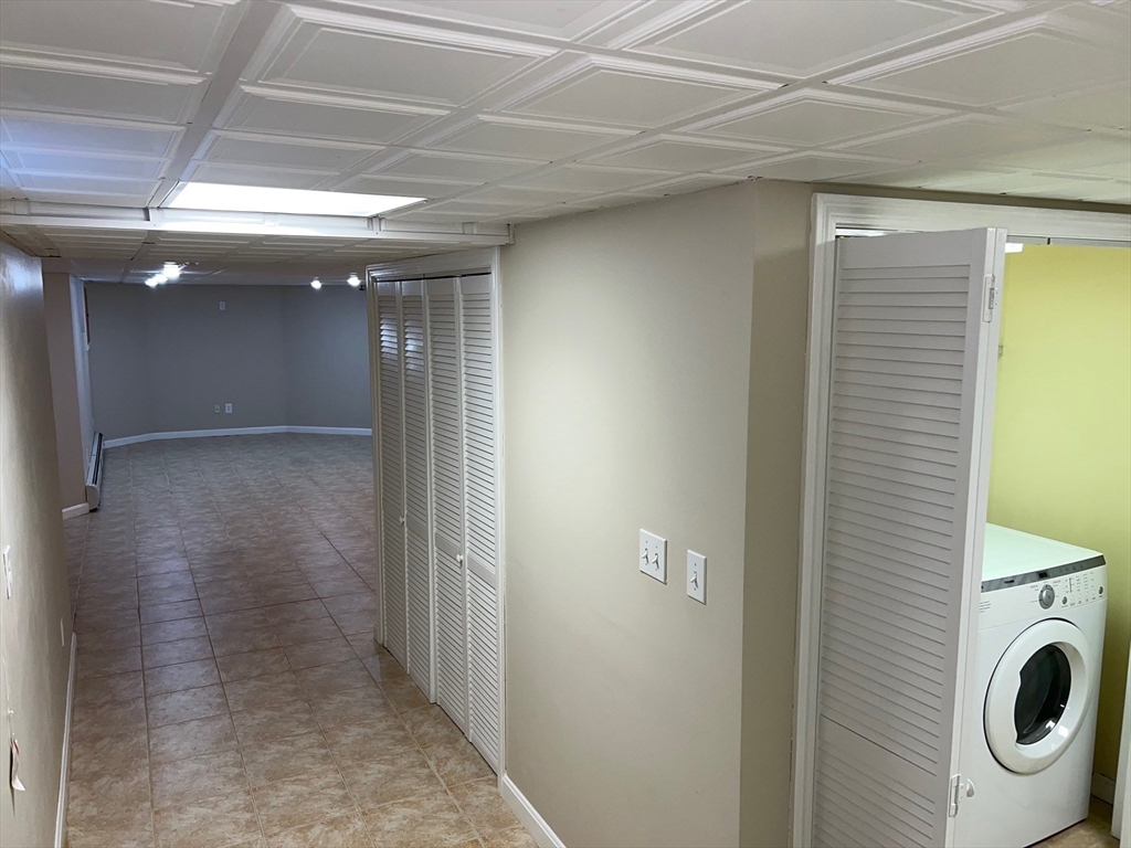 84 Melrose Street, Unit 1 Arlington, MA 02474 - Photo 37 of 42 a view of a hallway with washer and dryer