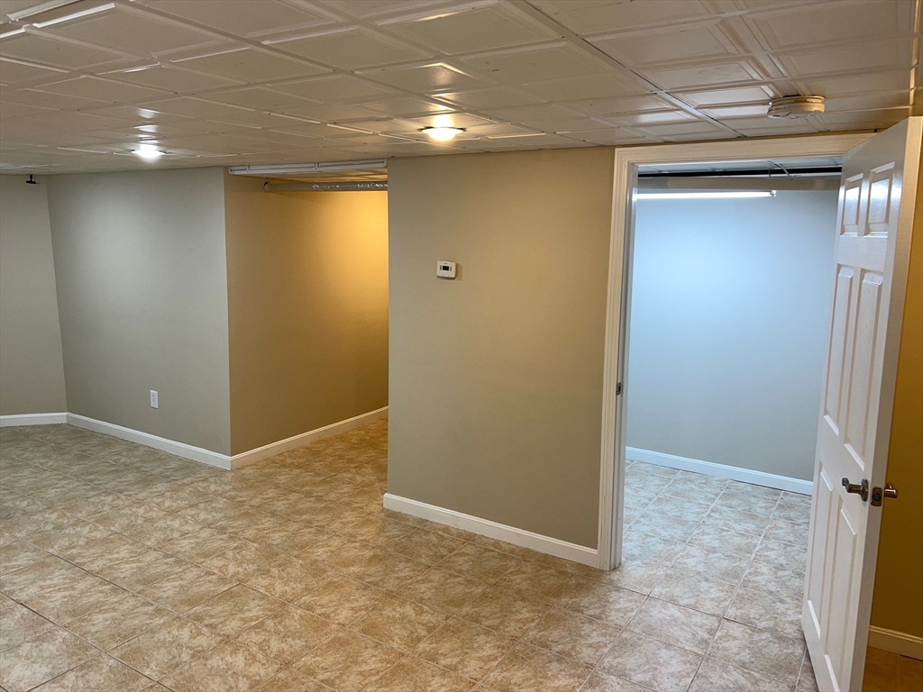 84 Melrose Street, Unit 1 Arlington, MA 02474 - Photo 39 of 42 an empty room with closet and wooden floor