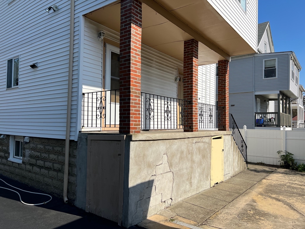 84 Melrose Street, Unit 1 Arlington, MA 02474 - Photo 8 of 42 a view of a house with a barbeque and wooden stairs