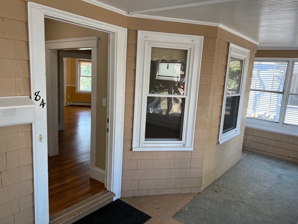 84 Melrose Street, Unit 1 Arlington, MA 02474 - Photo 10 of 42 a view of a hallway with wooden floor and stairs