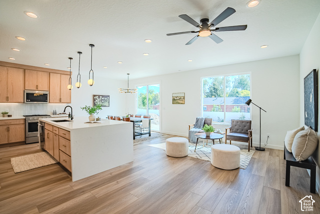 342 Perrine Drive Midvale, UT 84047 - Photo 4 of 37 Spacious open-concept living area featuring wood-finish flooring, recessed lighting, and a modern ceiling fan