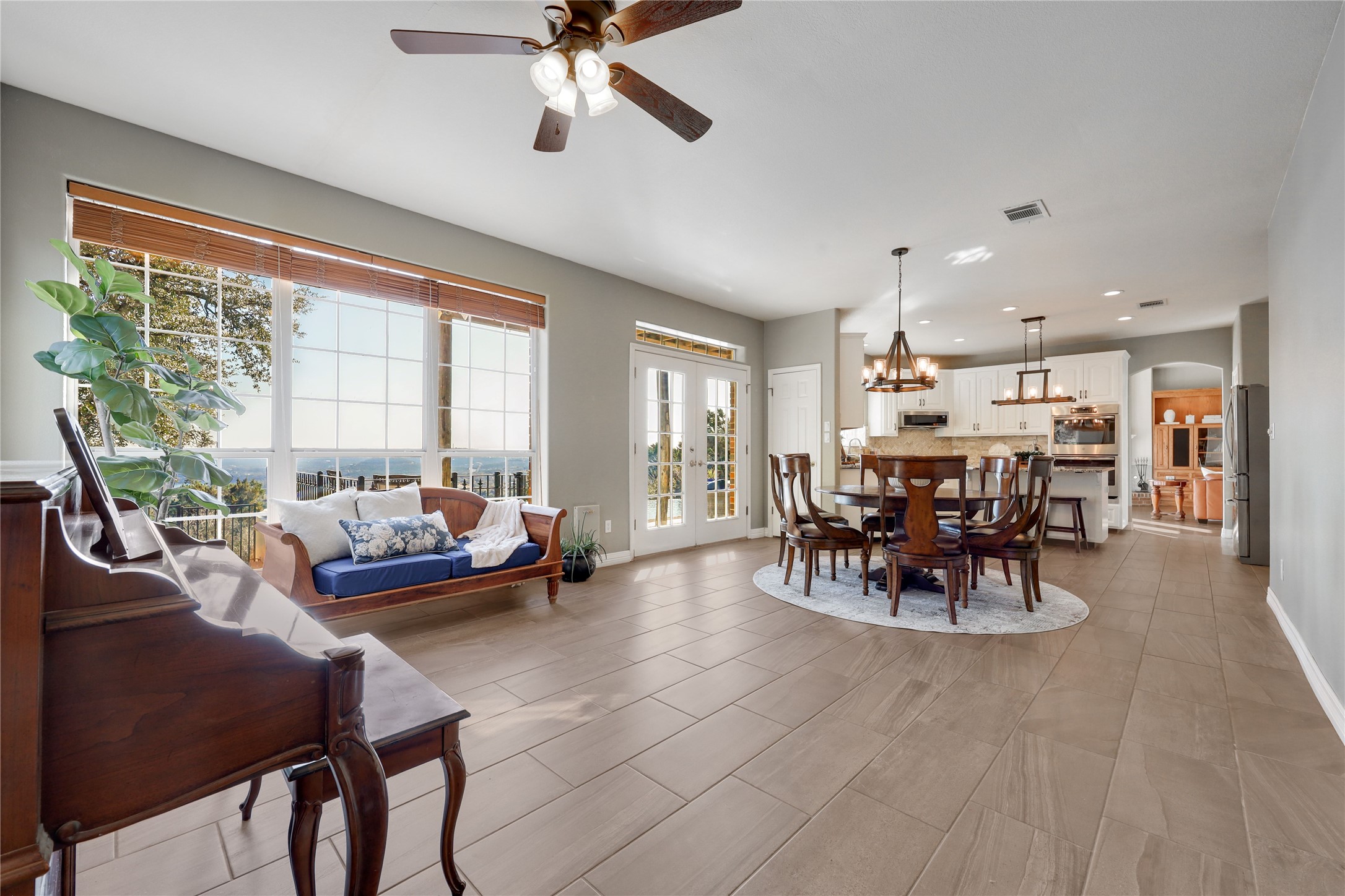 18607 White Rim Trail Jonestown, TX 78645 - Photo 15 of 40 Dining space with ceiling fan, arched walkways, a chandelier, and french doors
