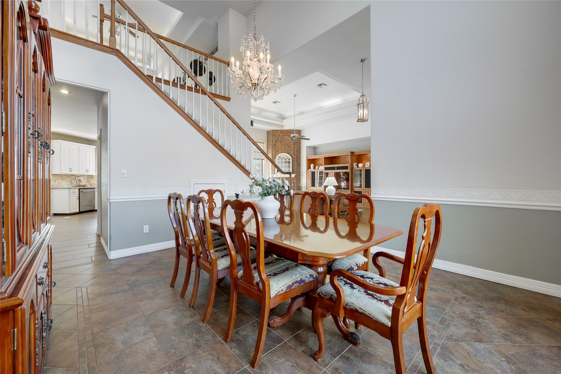 18607 White Rim Trail Jonestown, TX 78645 - Photo 17 of 40 Dining room with suspended lighting, dark stone finish floors, and ornamental molding