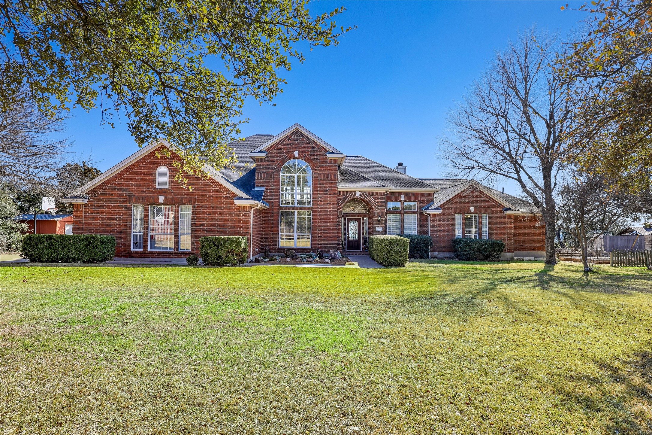 18607 White Rim Trail Jonestown, TX 78645 - Photo 2 of 40 Traditional-style home featuring brick siding and a front yard