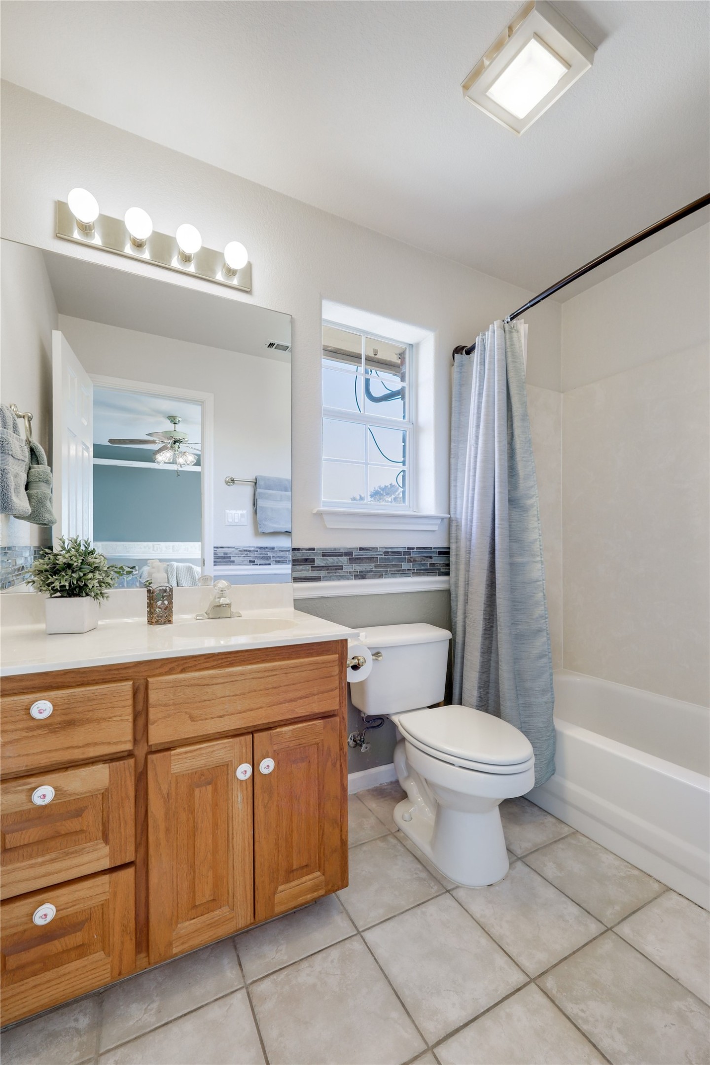 18607 White Rim Trail Jonestown, TX 78645 - Photo 30 of 40 Bathroom featuring vanity, shower / bath combo, and light tile patterned floors