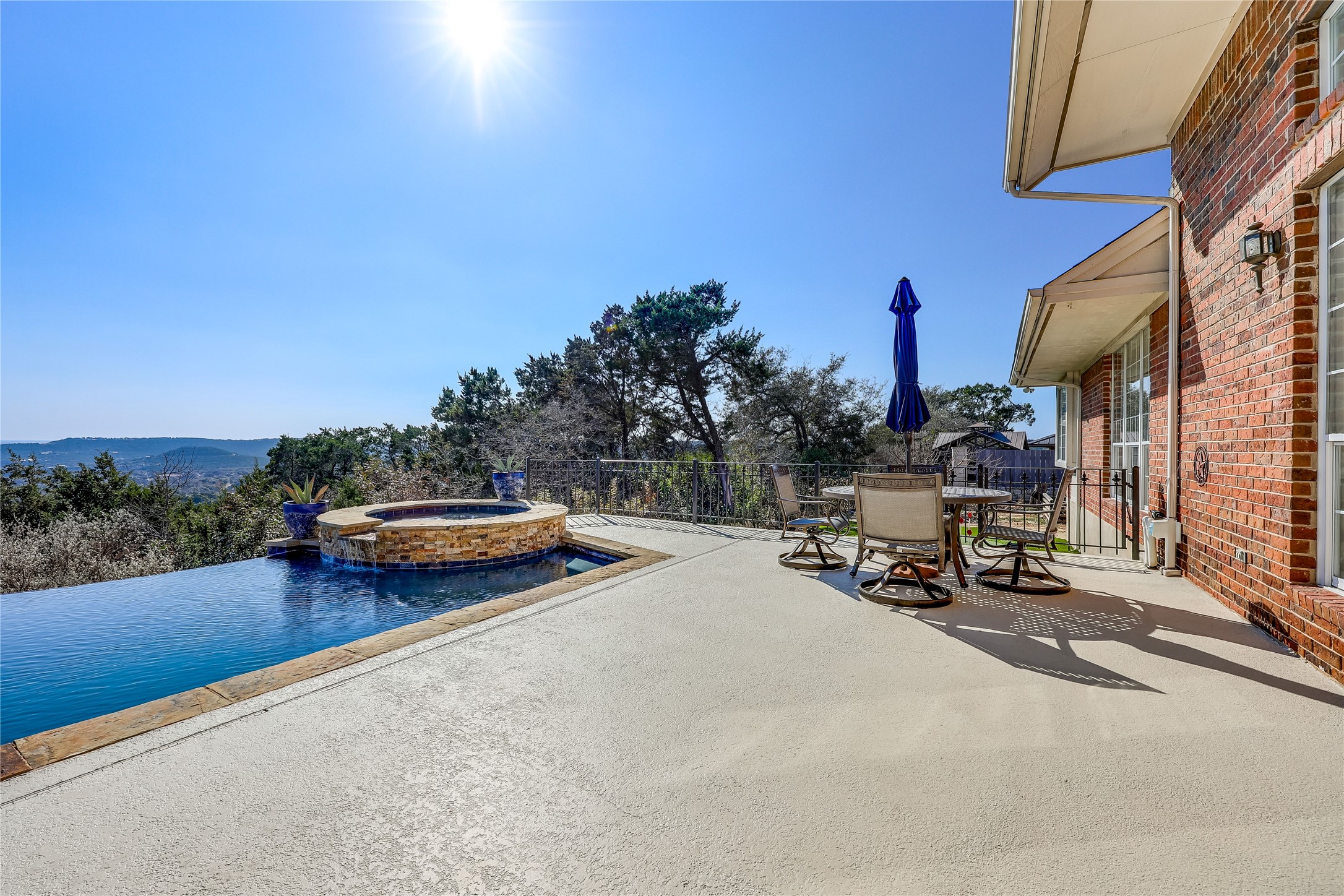 18607 White Rim Trail Jonestown, TX 78645 - Photo 34 of 40 Combined pool / hot tub featuring outdoor dining space and a patio