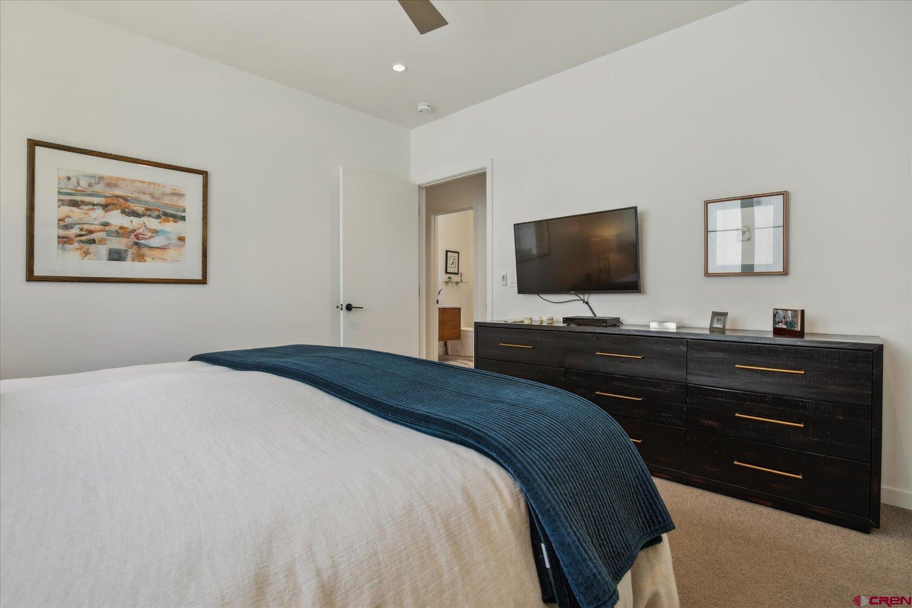 73 Jameson Drive Durango, CO 81301 - Photo 15 of 43 a bedroom with a bed and a flat screen tv