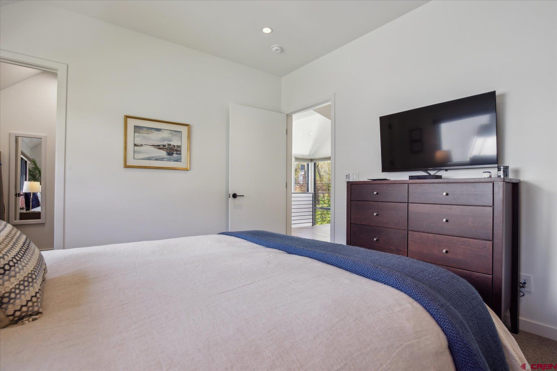 73 Jameson Drive Durango, CO 81301 - Photo 24 of 43 a bedroom with a bed and a flat screen tv