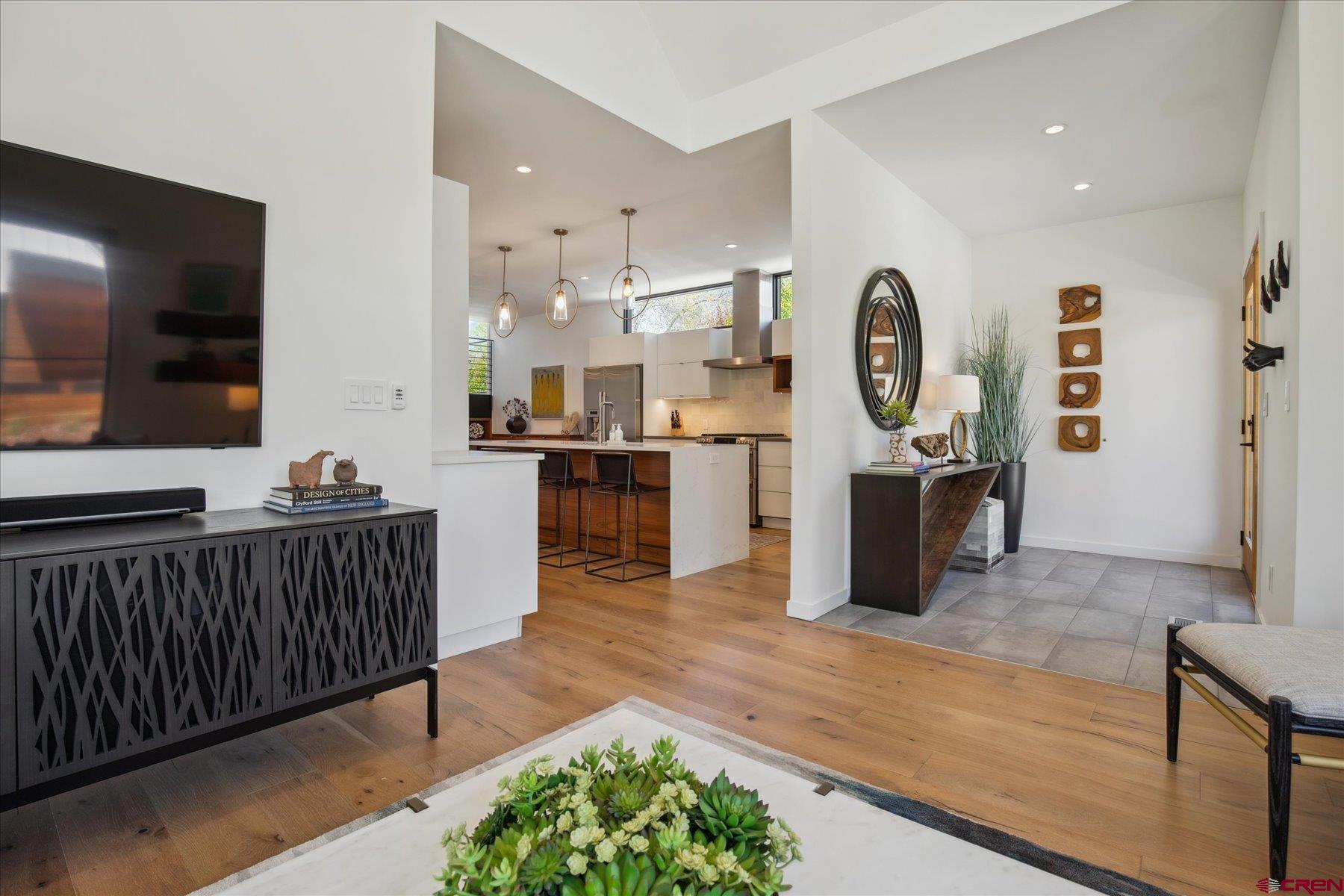 73 Jameson Drive Durango, CO 81301 - Photo 6 of 43 a open kitchen with stainless steel appliances granite countertop a stove top oven a sink dishwasher and white cabinets with wooden floor