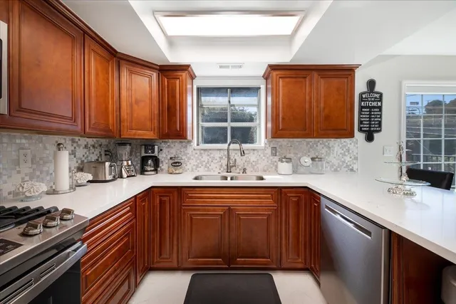 a kitchen with a sink stove top oven and cabinets