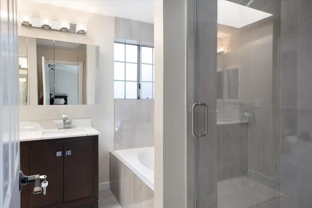 a bathroom with a double vanity sink a mirror and shower