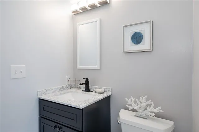 a bathroom with a sink vanity and mirror