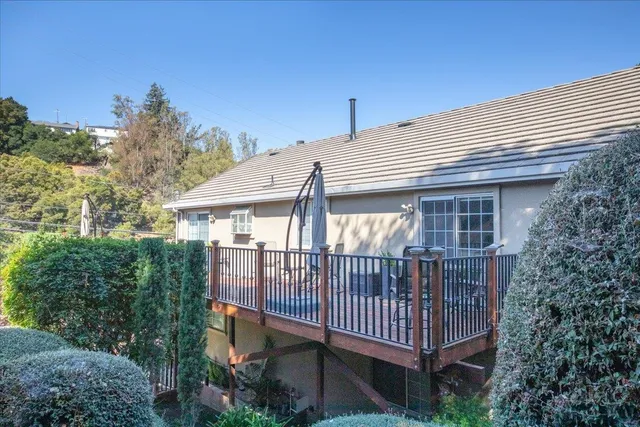a view of a house with a yard and deck
