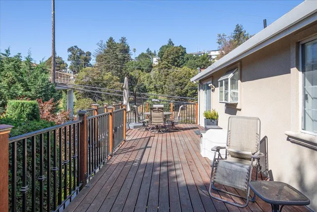 a view of balcony with wooden floor and fence