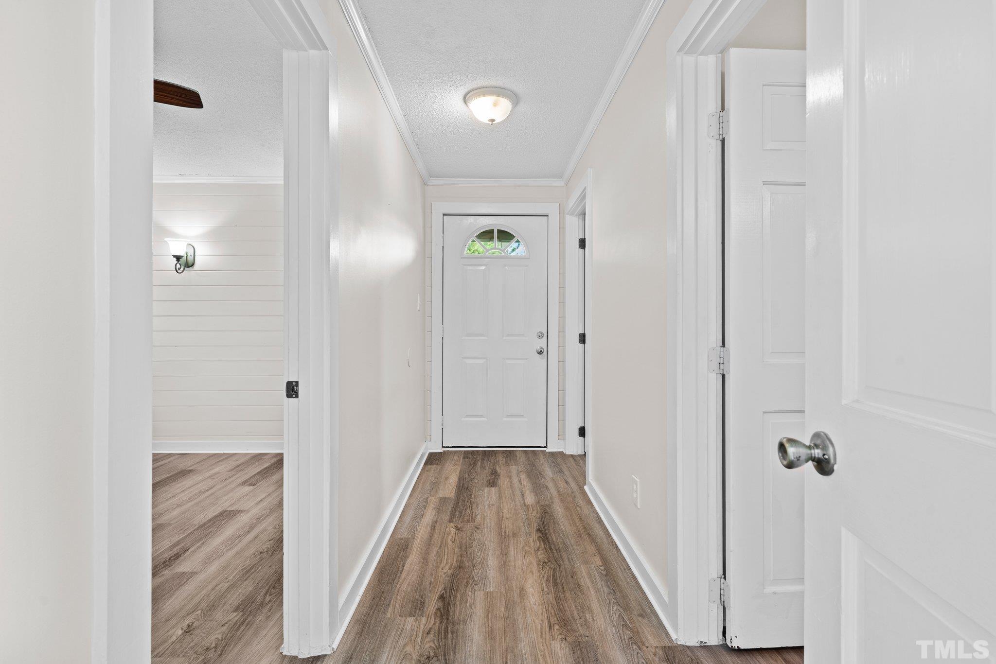 2929 Wall Store Road Garner, NC 27529 - Photo 25 of 59 a view of a hallway with wooden floor and closet area