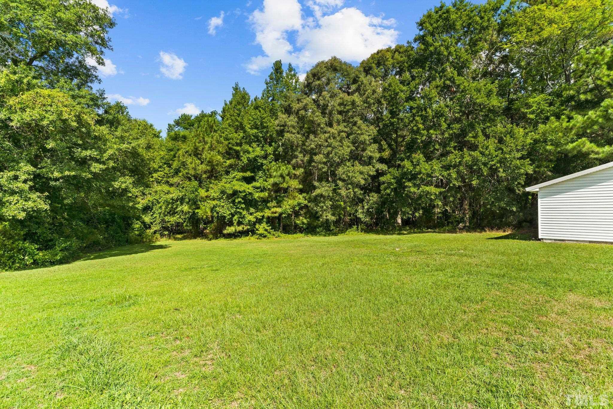2929 Wall Store Road Garner, NC 27529 - Photo 42 of 59 a view of a field with an trees