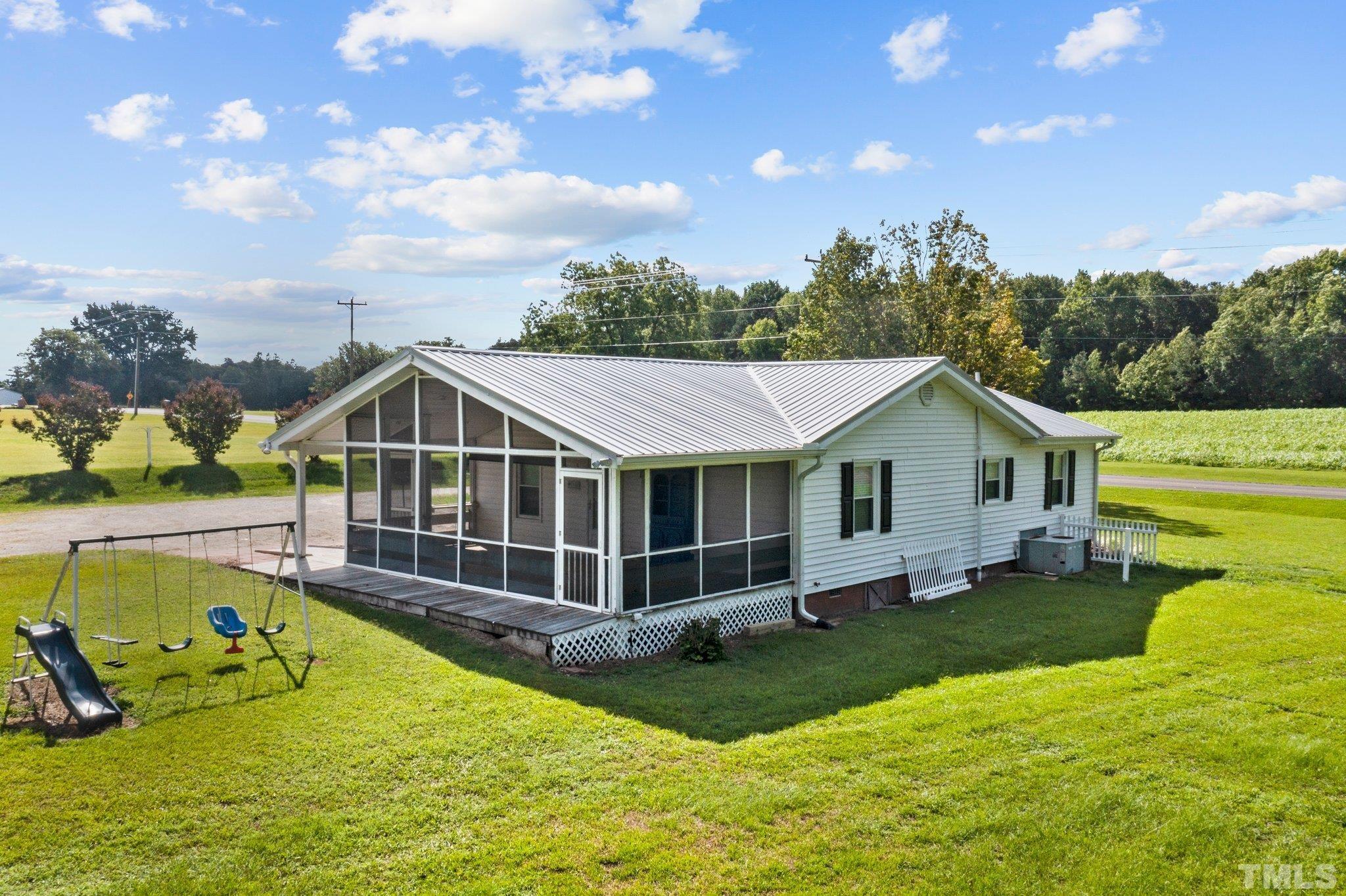 2929 Wall Store Road Garner, NC 27529 - Photo 43 of 59 a view of a house with a big yard potted plants and large tree