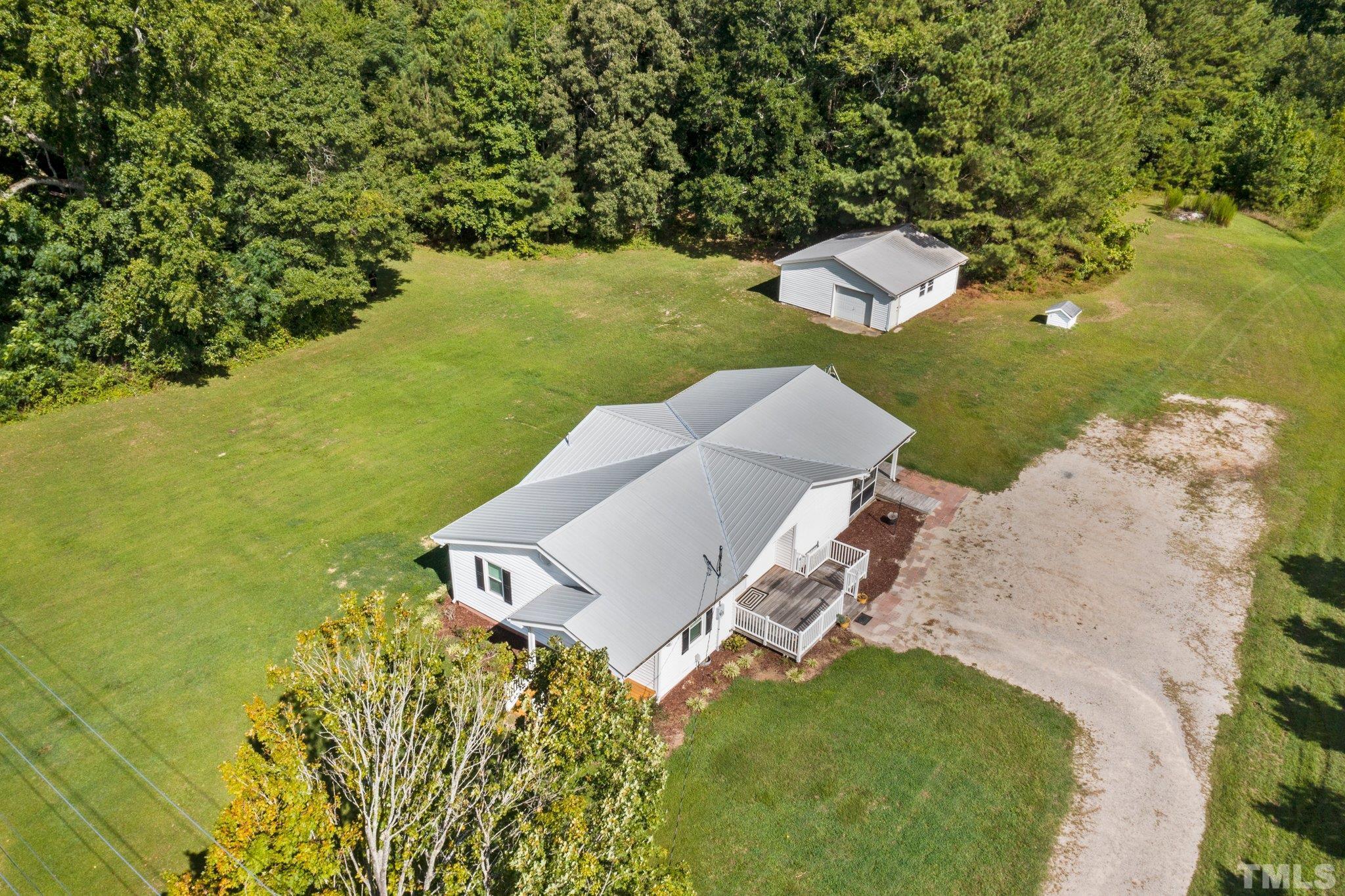 2929 Wall Store Road Garner, NC 27529 - Photo 52 of 59 an aerial view of a house with a yard and lake view