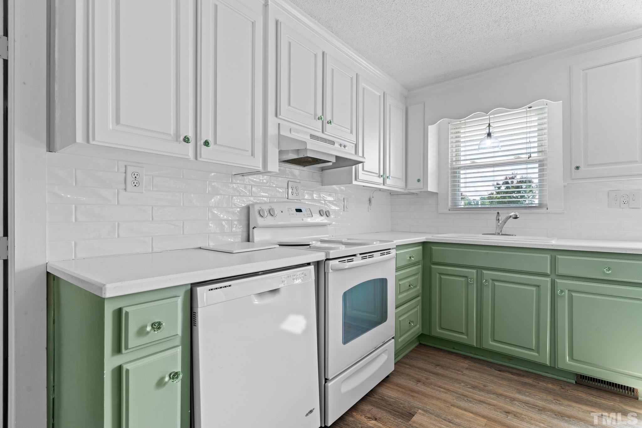 2929 Wall Store Road Garner, NC 27529 - Photo 8 of 59 a kitchen with stainless steel appliances granite countertop a sink and cabinets with wooden floors