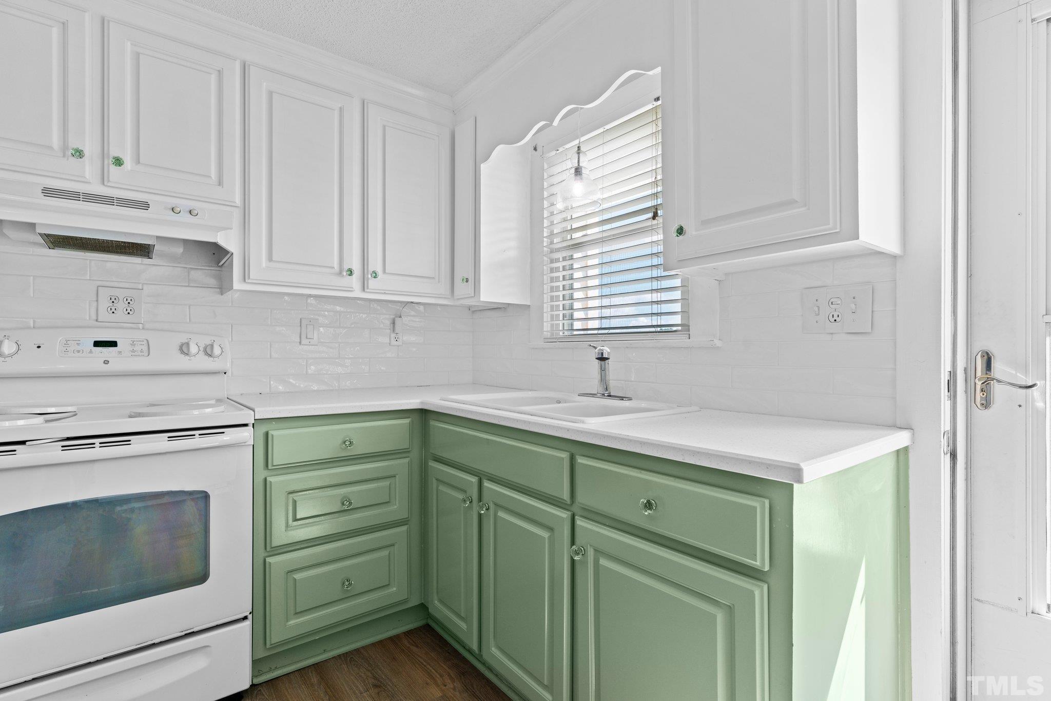 2929 Wall Store Road Garner, NC 27529 - Photo 9 of 59 a kitchen with cabinets appliances a sink and a window