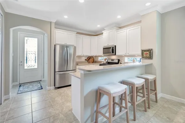 a kitchen with stainless steel appliances a refrigerator stove microwave and cabinets