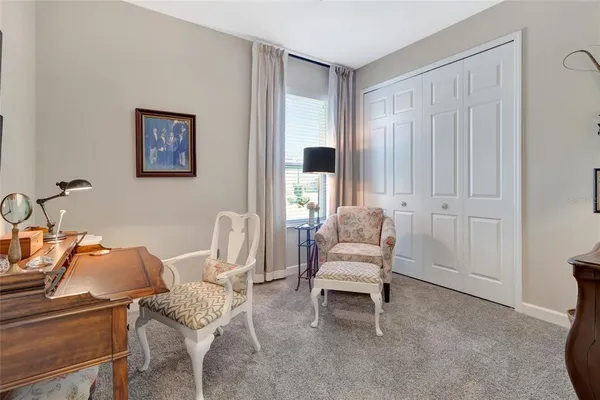 a living room with furniture and a chair