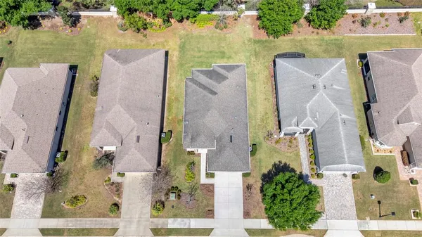 an aerial view of a house with outdoor space and swimming pool