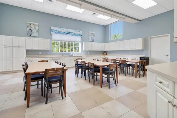 a kitchen with lots of chairs and a dining table
