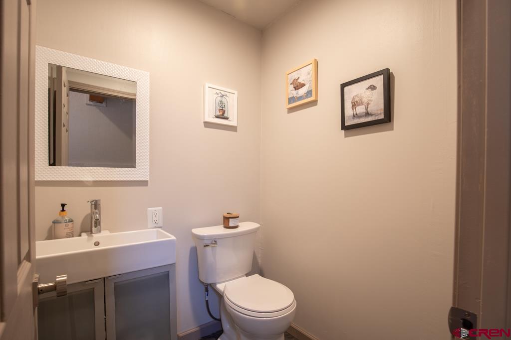 306 Hogan Circle Durango, CO 81301 - Photo 15 of 39 a bathroom with a toilet a sink and mirror