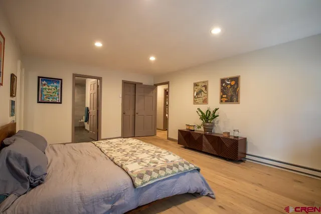 a bedroom with a bed and dresser