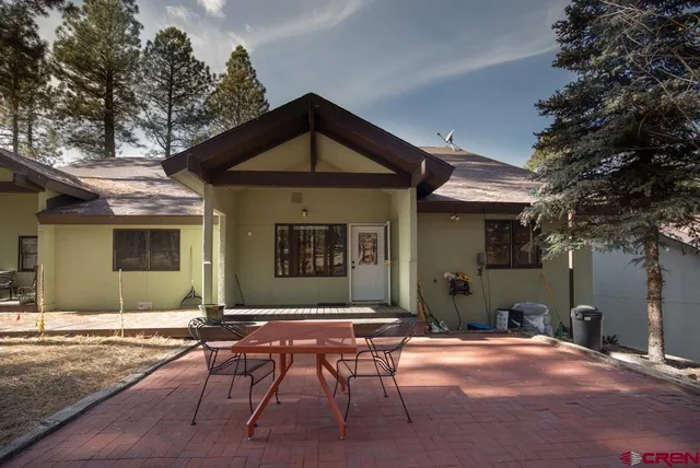 a front view of a house with yard outdoor seating and barbeque oven