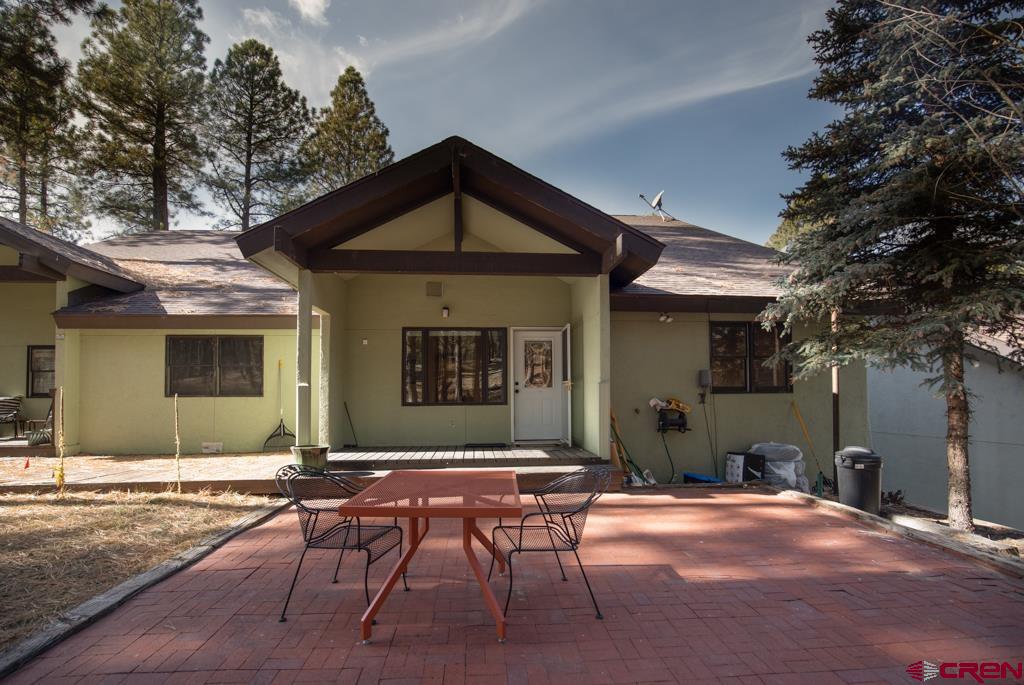 306 Hogan Circle Durango, CO 81301 - Photo 22 of 39 a front view of a house with yard outdoor seating and barbeque oven