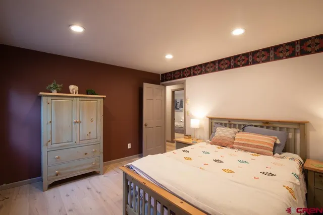 a bedroom with a bed and a dresser