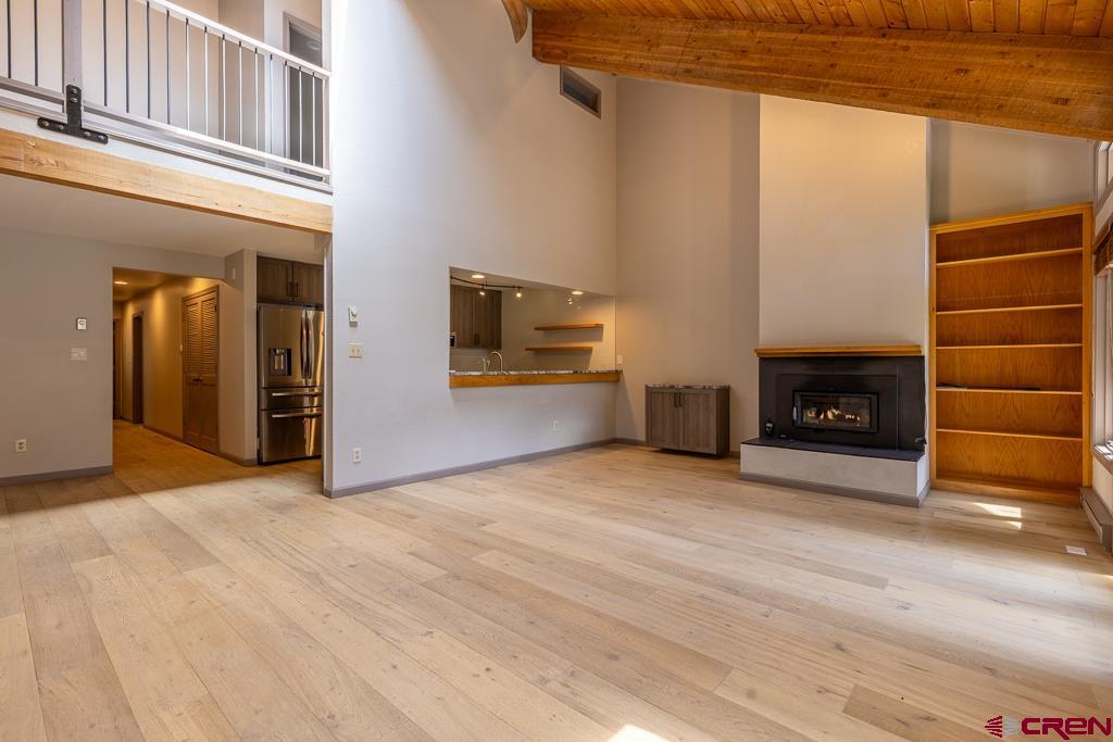 306 Hogan Circle Durango, CO 81301 - Photo 3 of 39 a view of an empty room with a fireplace and a window