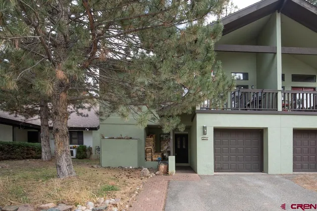 a view of a house with a yard and garage