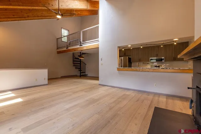a view of a living room with kitchen