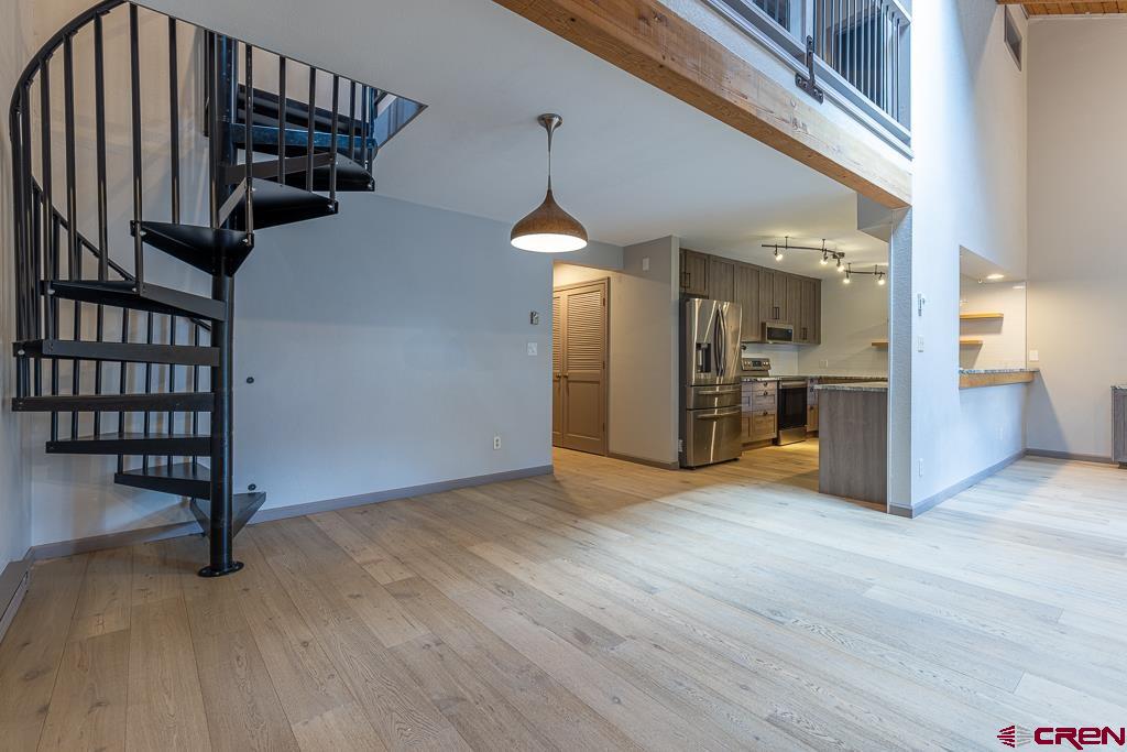 306 Hogan Circle Durango, CO 81301 - Photo 9 of 39 an empty room with wooden floor and windows