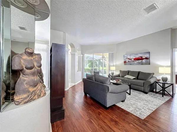 a living room with furniture and a wooden floor
