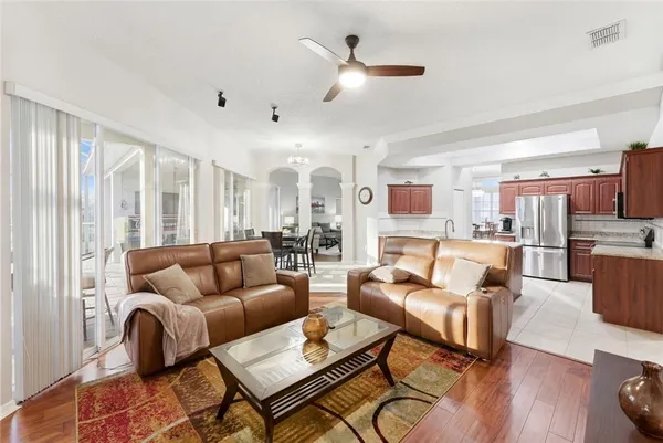 a living room with furniture fireplace and a large window