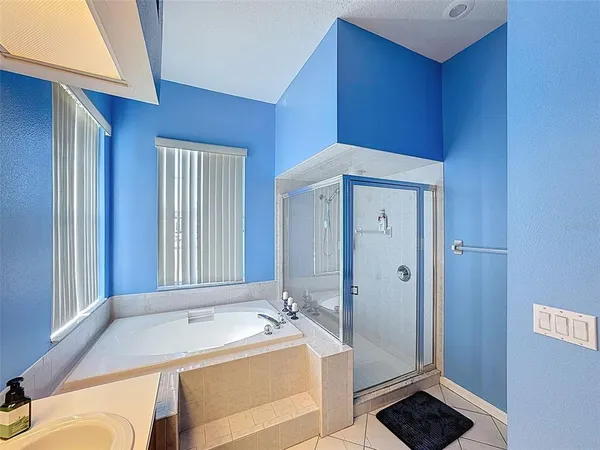 a bedroom with two beds and a flat screen tv